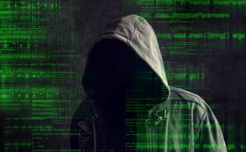 Faceless hooded anonymous computer hacker